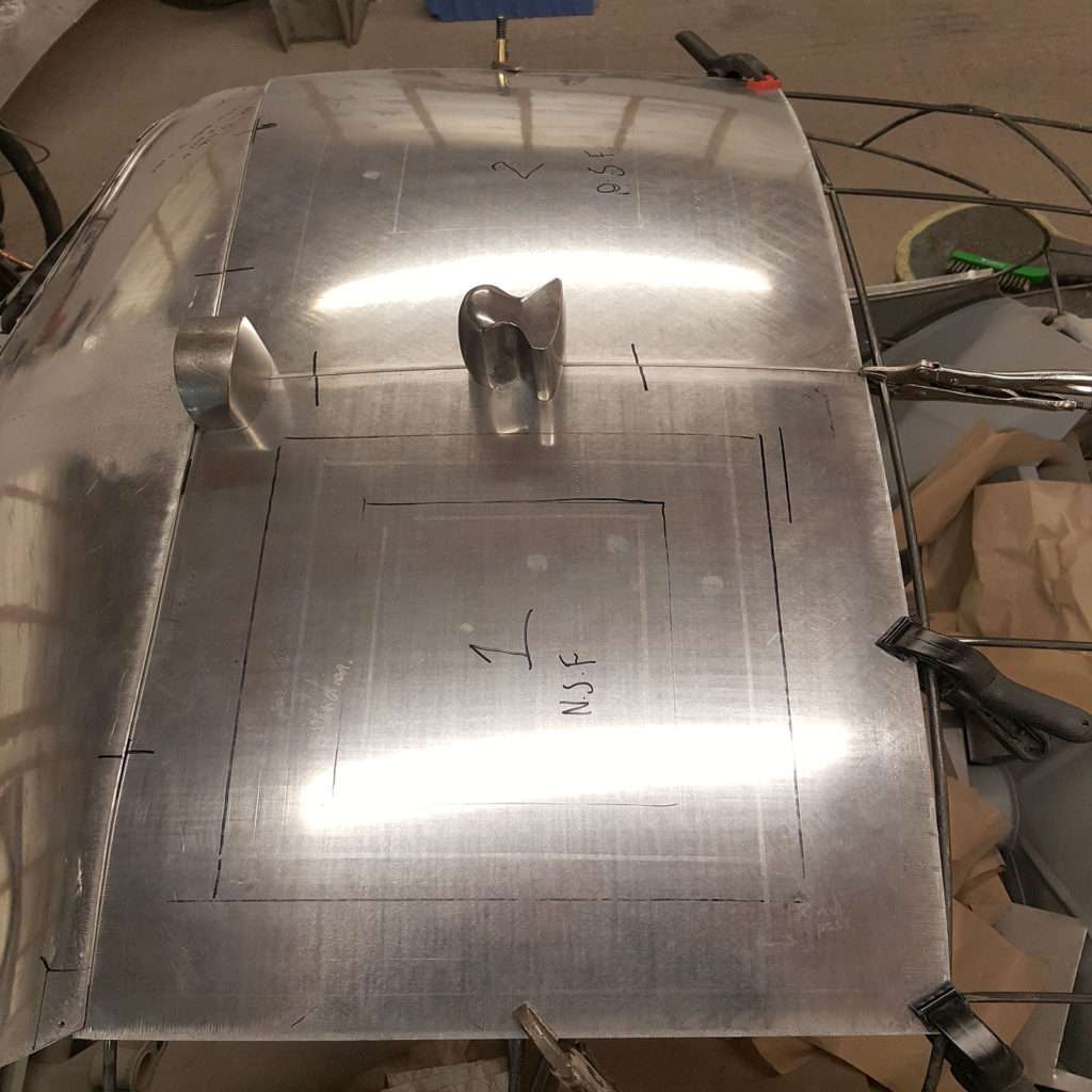 We're carefully placing the centre of the roof and expertly joining it onto the sides of the 1953 Jowett Jupiter.