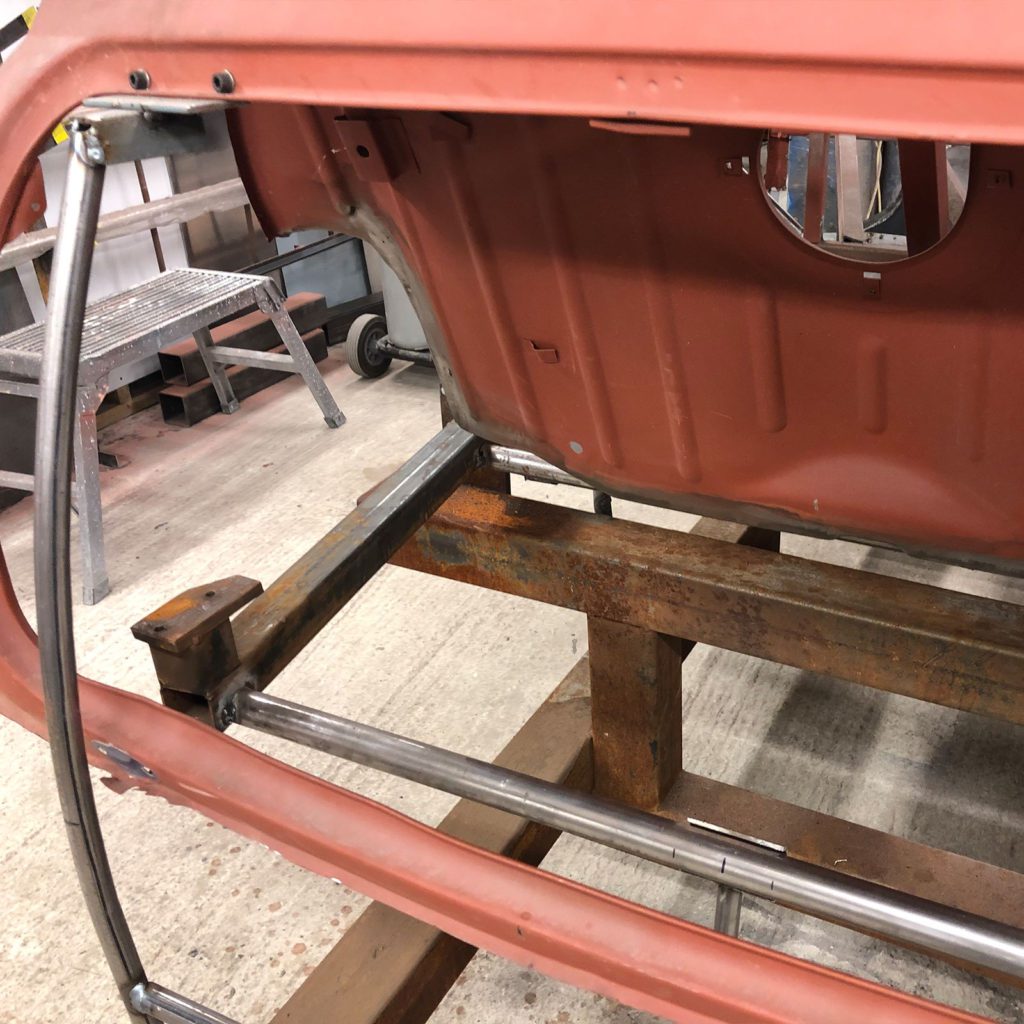 The Plastics4Performance Mini Cooper 998 MkII on a jig to keep things all in-line for when the modified boot floor goes in.